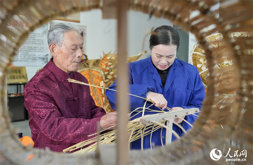 Foto Yu Fangze, seorang pewaris warisan budaya tidak ketara kebangsaan anyaman naga straw dan anak perempuannya di kaunti Hukou, bandar Jiujiang, Provinsi Jiangxi, timur China. (People’s Daily Online/Kong Wenjin)